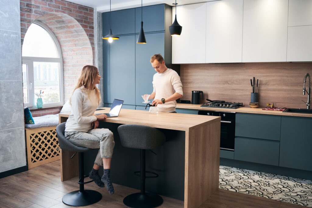 Une cuisine équipée sur mesure terminée avec îlot central et électroménager encastré.